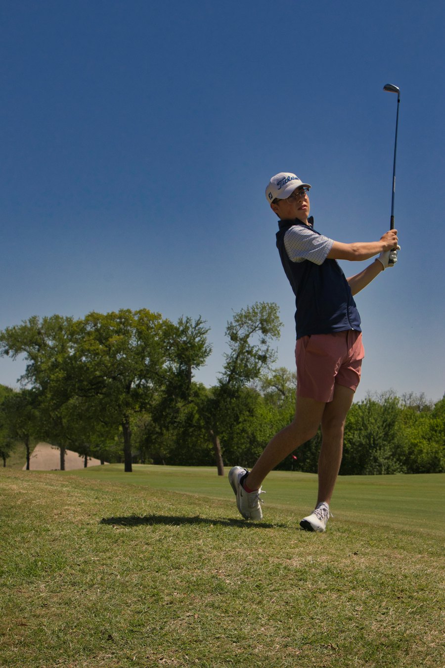 Daniyal Qureshi holding his follow-through on a practice fairway